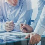 men writing down notes
